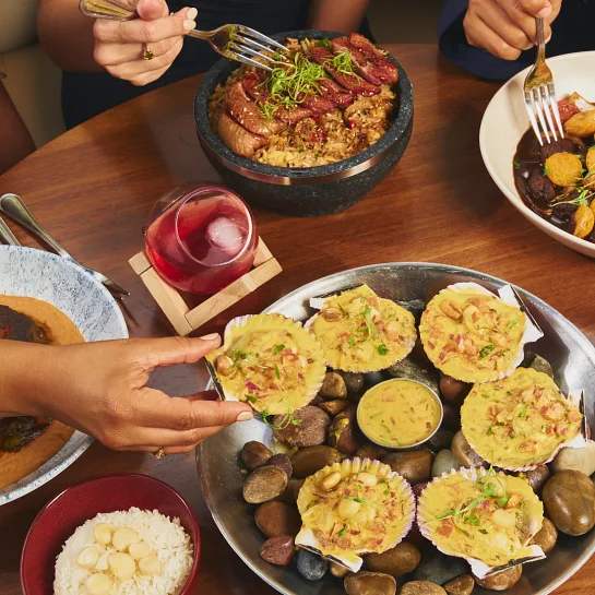 Guests sharing scallops and Peruvian dishes